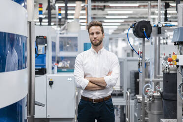 Portrait of a confident businessman in a modern factory - DIGF07632