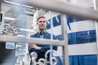 Portrait of a confident businessman in a modern factory - DIGF07639