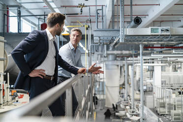 Two businessmen talking in a modern factory - DIGF07655