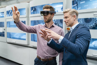 Two businessmen with AR glasses in a modern factory - DIGF07694