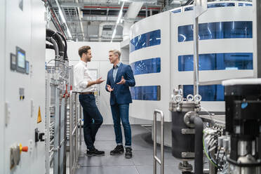 Two businessmen talking in a modern factory - DIGF07708
