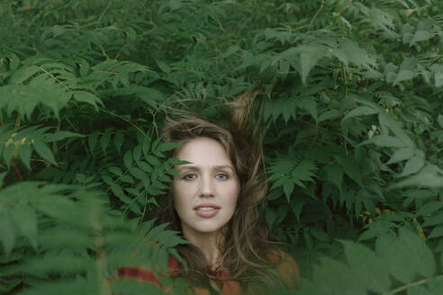 Face of young woman amidst plants - AHSF00597