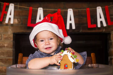 Caucasian boy holding gingerbread house - BLEF10269