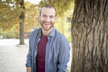 Caucasian man smiling in park - BLEF10274