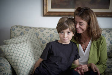 Caucasian grandmother and grandson sitting on sofa - BLEF10278