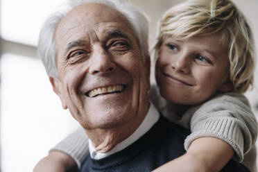 Happy grandson hugging grandfather - GUSF02174