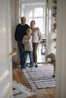 Portrait of happy grandparents with grandson at home - GUSF02201