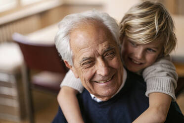 Happy grandson hugging grandfather - GUSF02274