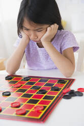 Frustrated Vietnamese playing checkers game - BLEF10325