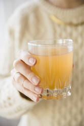 Close up of Caucasian woman holding glass of punch - BLEF10363