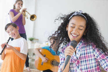 Happy children singing and playing music - BLEF10379