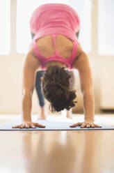 Close up of Hispanic woman practicing yoga in studio - BLEF10386