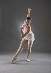 Hispanic ballet dancer posing on tip toe - BLEF10395