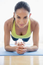 Caucasian woman exercising on yoga mat - BLEF10455