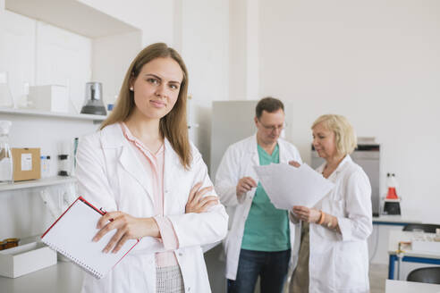 Portrait of young researcher in white coat in a lab - AHSF00616