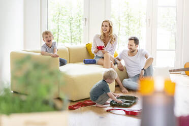 Happy family with two sons in living room of their new home - PESF01661