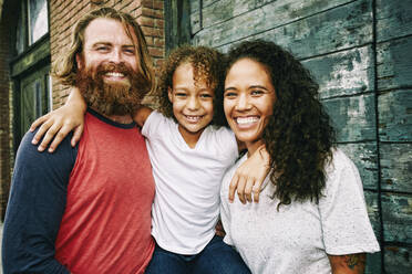 Family hugging outdoors - BLEF10581