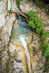 Aerial view two men canyoning. - AAEF00024