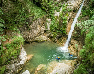 Aerial view two men canyoning. - AAEF00025