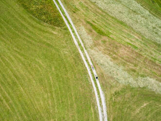 Aerial view of cyclists on a dirt track in Soca valley, Slovenia. - AAEF00040