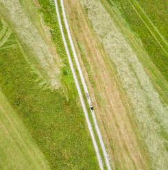 Aerial view of cyclists on a dirt track in Soca valley, Slovenia. - AAEF00042