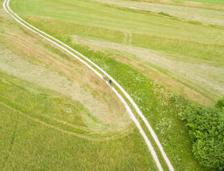 Aerial view of cyclists on a dirt track in Soca valley, Slovenia. - AAEF00046