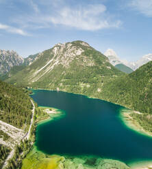 Aerial view of Lago del Predil lake surrounded by mountains, Italy. - AAEF00052