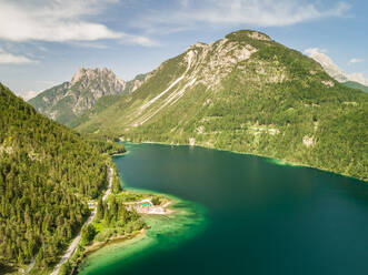 Aerial view of Lago del Predil lake surrounded by mountains, Italy. - AAEF00054