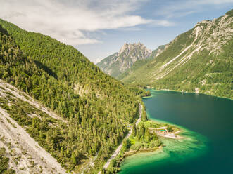 Aerial view of Lago del Predil lake surrounded by mountains, Italy. - AAEF00055