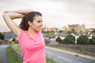 Caucasian woman stretching outdoors - BLEF10798