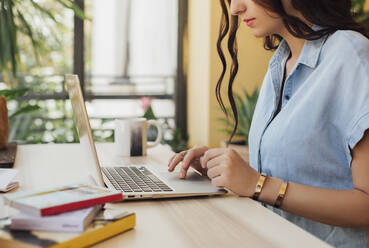 Caucasian woman using laptop at desk - BLEF10930