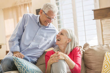 Caucasian couple sitting on sofa - BLEF10940