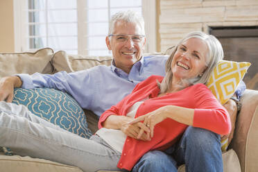 Caucasian couple relaxing on sofa - BLEF10947