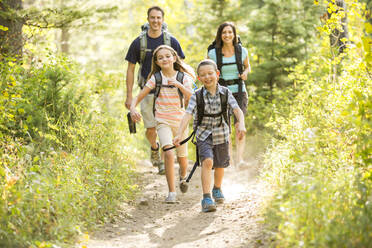 Caucasian family hiking on path - BLEF10971