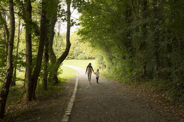 Caucasian mother and son walking in park - BLEF11008