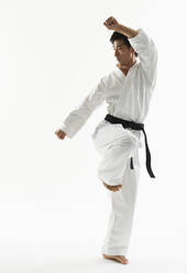 Asian male black belt practicing karate - BLEF11141