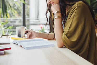 Caucasian woman studying at desk - BLEF11304