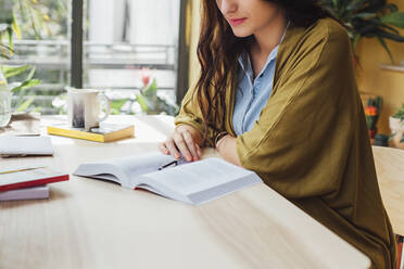 Caucasian woman studying at desk - BLEF11305