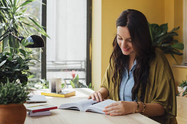 Caucasian woman studying at desk - BLEF11306