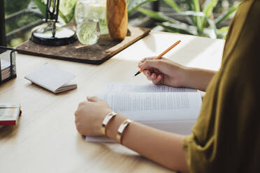 Caucasian woman studying at desk - BLEF11311