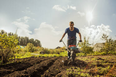 Caucasian man working in garden - BLEF11369