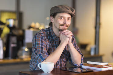 Caucasian man smiling in cafe - BLEF11436