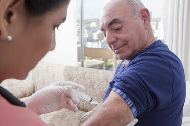 Hispanic nurse giving patient injection - BLEF11498