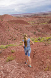 Caucasian girl walking on rural hilltop - BLEF11648