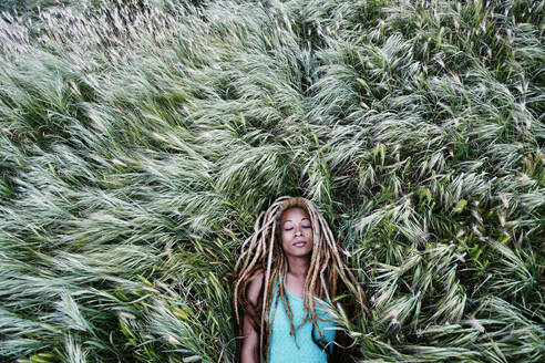 Black woman laying in grass - BLEF11689