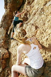 Women climbing on boulders - BLEF11717