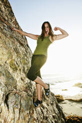 Woman climbing rock formation - BLEF11729