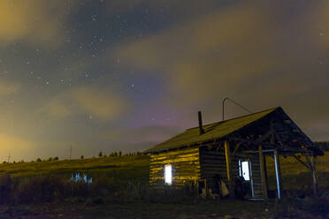Cabin in rural field at night - BLEF11787