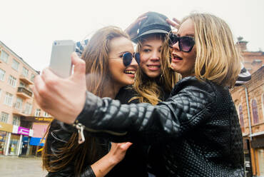 Caucasian women taking selfie in city - BLEF11851