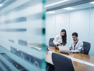 Business people using technology in conference room - BLEF11874